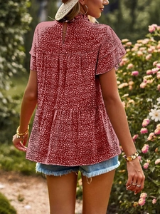 Detail of red chiffon top featuring tiered ruffles and a back teardrop cutout