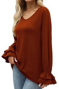 Close-up of caramel knit top with ruffled bell sleeves and delicate ribbed texture detail