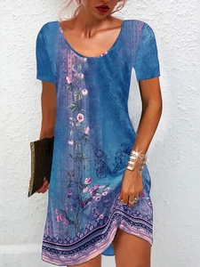 Detail of floral print and geometric hem pattern on a blue summer mini dress