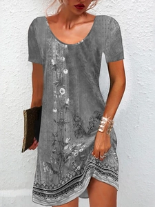 Detail of short-sleeved summer dress featuring grey floral patterns and ethnic geometric hem