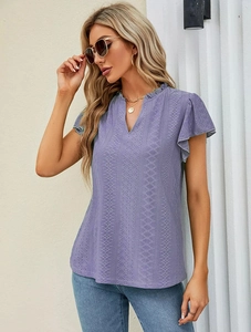 Close-up of lilac lace short sleeve top featuring hollow-out geometric patterns and V-neckline