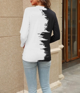 Detail view of women's long sleeve T-shirt with black and white artistic paint splash design