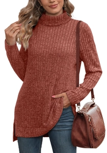 Detail of rust red turtleneck knit top with side slits and ribbed texture fabric