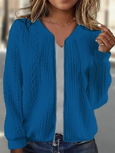 Detail of royal blue cable knit cardigan with silver zipper and ribbed cuffs