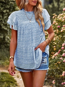 Close-up of light blue polka dot chiffon blouse with ruffled sleeves and pleated collar