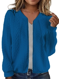 Detail of blue cable knit sweater featuring a metal zipper and ribbed stand collar texture