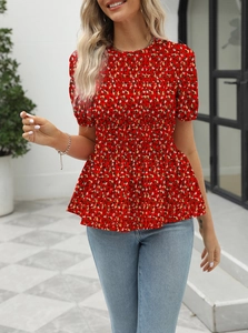 Detail of red floral short sleeve blouse featuring elastic smocking and ruffle hem