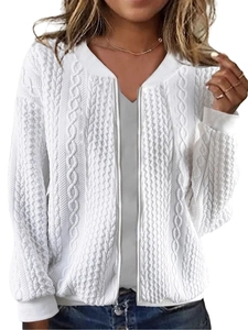 Detail shot of white cable knit texture and metal zipper on this women's cardigan