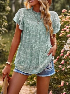 Detail of mint green chiffon top featuring white animal print and ruffled sleeve edges