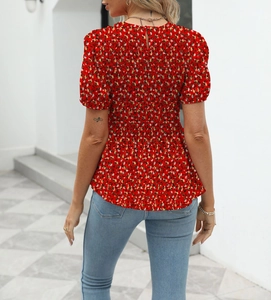 Back view of a red floral smocked short sleeve blouse with back neck button detail
