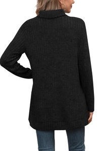 Detail of black ribbed knit turtleneck showing the fine vertical texture and soft fabric