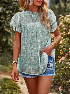 Detail view of mint green polka dot chiffon top featuring double layered ruffle sleeves