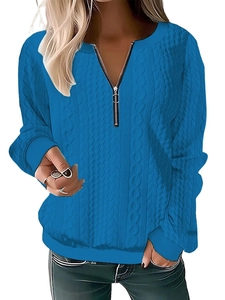 Detail of the bright blue long sleeve knit sweater with textured cable knit and half zipper
