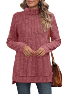 Detail view of pink turtleneck knit top showing side slit and ribbed texture
