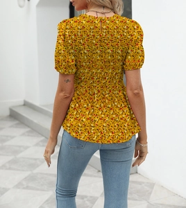 Detailed back view of yellow floral blouse showing elastic smocking and back button closure