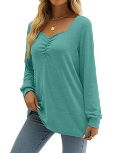 Close-up of ruched V-neck detailing on a teal long-sleeve knit top for women