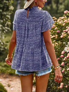 Detail of blue floral chiffon blouse featuring ruffle sleeves and a tiered layered hem