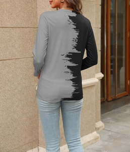 Detail view of women's long sleeve T-shirt with artistic black and grey color block design