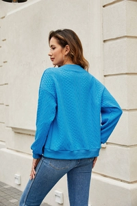 Detailed back view of navy blue cable knit sweatshirt showing rich fabric texture