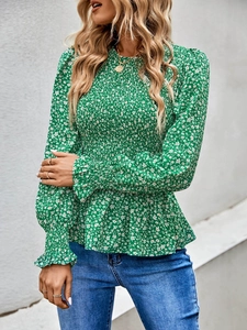 Detail of smocked chest texture and ruffle hem on emerald floral long sleeve blouse