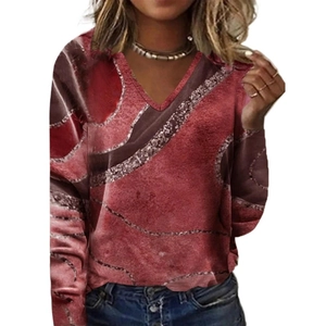 Detail of V-neck long sleeve top with red marble print and glitter wave patterns