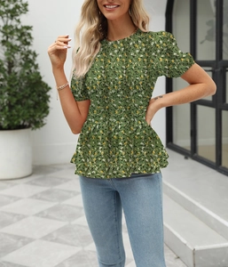 Detail of smocked waist and peplum hem on dark green floral short sleeve top