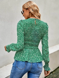 Detail of smocked back design on green floral long sleeve blouse with ruffled hem