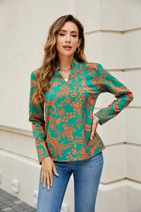 Close-up of V-neckline on emerald green floral long sleeve shirt for women