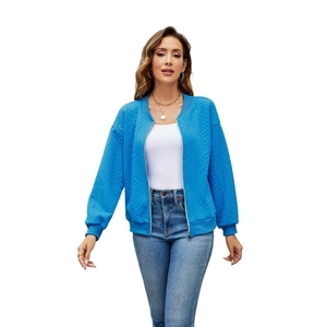 Detailed view of women's bright blue zip-up jacket with textured diamond knit pattern