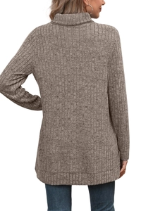 Detail of the soft ribbed knit texture and drape on a taupe high-neck long-sleeve sweater