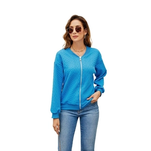 Detailed cable knit texture and silver zipper on bright blue women's cardigan