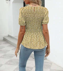 Detail of floral summer shirt featuring back smocked elastic waist and ruffled hem
