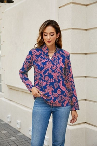 Detail of blue floral print blouse featuring a V-neckline and elegant long sleeves