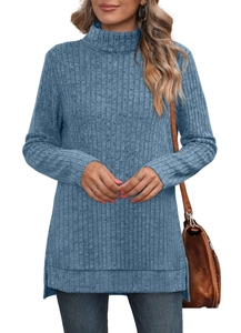 Detail view of the ribbed knit fabric and side slit hem on this blue turtleneck sweater