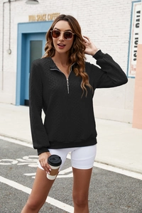 Detailed view of the diamond-pattern jacquard texture on this black half-zip sweatshirt