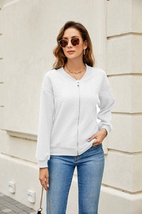 Detailed cable knit texture and silver zipper on white women's sweater jacket