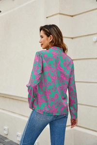 Floral print long sleeve V-neck blouse detail featuring vibrant green and pink patterns