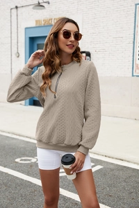 Detailed close-up of khaki half-zip sweatshirt featuring a rich cable knit texture finish