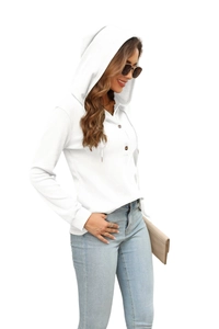 Detailed view of white waffle knit texture and buttoned neckline of the hooded top