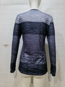 Women's crewneck long sleeve tee with grey and navy horizontal gradient stripes on a mannequin