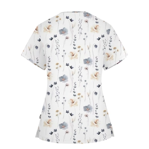 Detailed view of floral print nurse scrub top with side slits and short sleeves