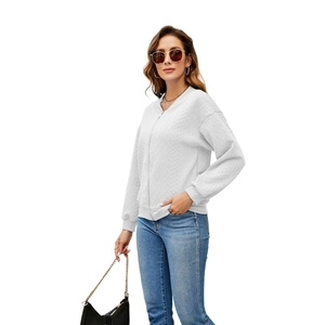 Detailed view of the white cable knit pattern and metal zipper on this women's cardigan