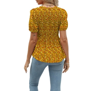 Detailed back view of women's yellow floral short sleeve top with smocking technique