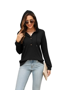 Detailed view of women's black waffle knit hoodie with drawstring and button neckline