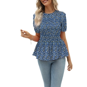 Detail of floral short sleeve blouse featuring smocked bodice and peplum hem design