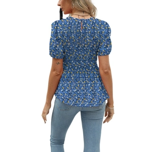 Rear view of floral blue short sleeve blouse with ruched waist and chiffon texture