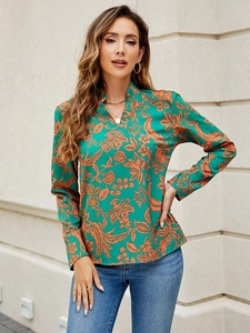 Floral V-neck long sleeve green blouse featuring tropical orange leaves with denim jeans