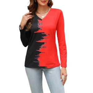 Detail of V-neck long sleeve top with irregular red and black color block pattern