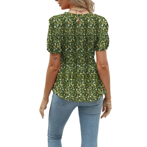Rear view of floral smocked waist top featuring puff sleeves and back teardrop button