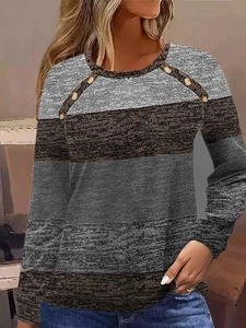 Detail shot of elegant copper buttons on striped knit crewneck long sleeve shirt for women